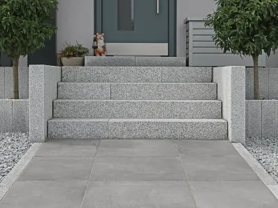 Einladende Treppe am Hauseingang aus Granit-Naturstein mit vorgelagerten Pflasterarbeiten.