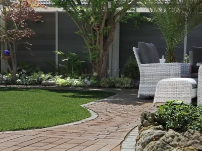 Elegante Gartengestaltung mit geschwungenen Pflasterarbeiten und modernen Zäunen als verlässlicher Sichtschutz.